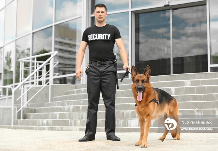 Security guard with dog near building