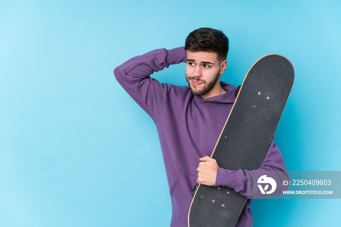 Young caucasian skater man isolated touching back of head, thinking and making a choice.