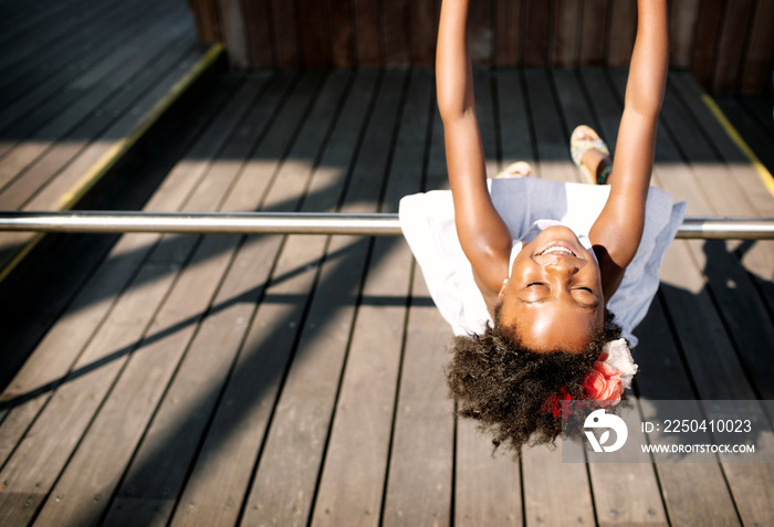 Girl (4-5) hanging down