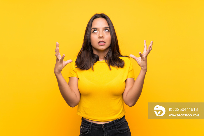 Young brunette girl over isolated background frustrated by a bad situation