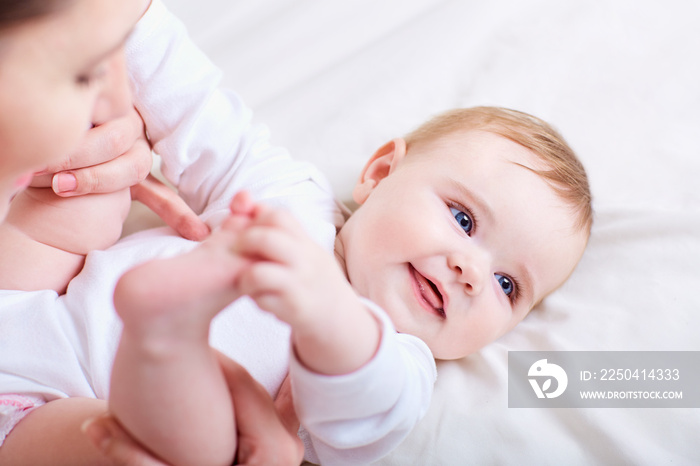 Mother and baby playing and laughing.Happy family.Child looks up