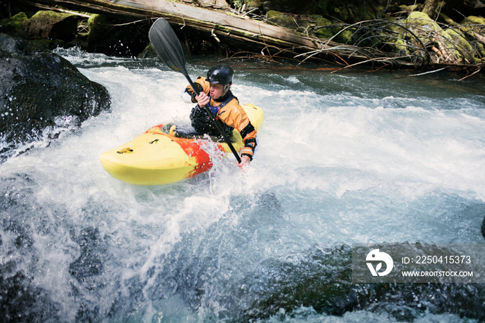 Young man canoeing in river