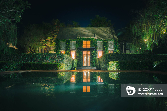 Beautiful decoration of English country style building covered with green creeper plant at night