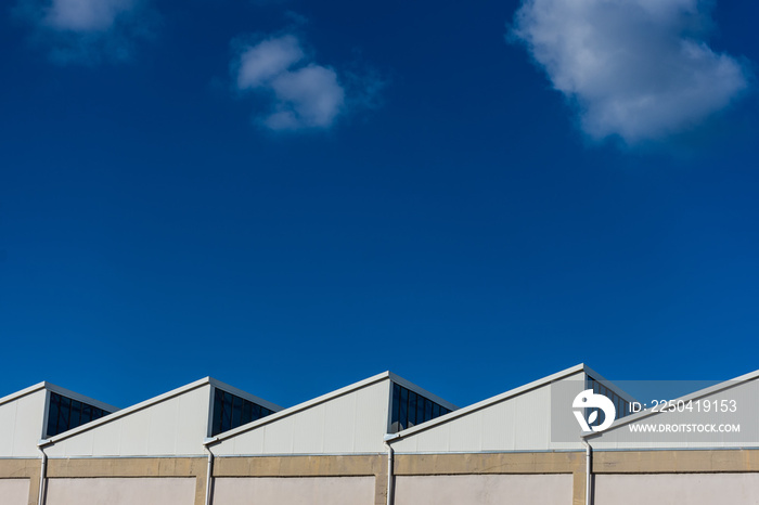 View of factory rooftops on sunny day