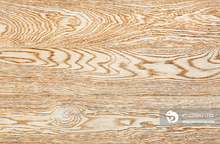 Beige wood surface texture with horizontal grains, close-up.