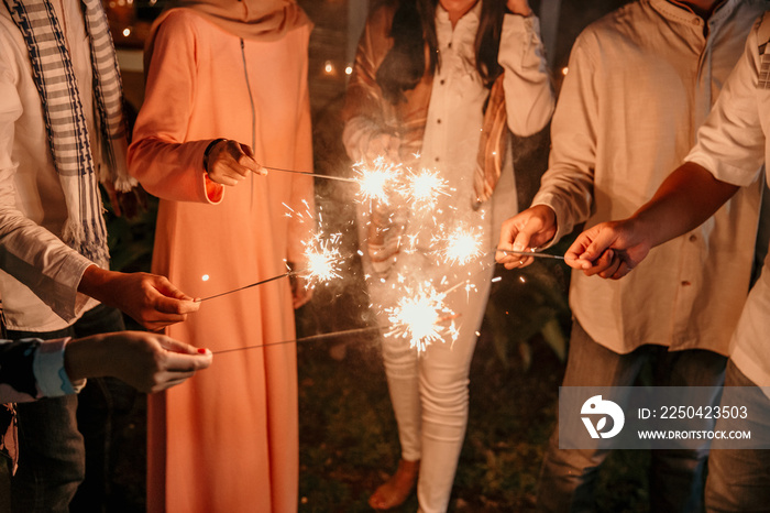 happiness lighting the takbir night fireworks with friends while celebrating the Eid holiday