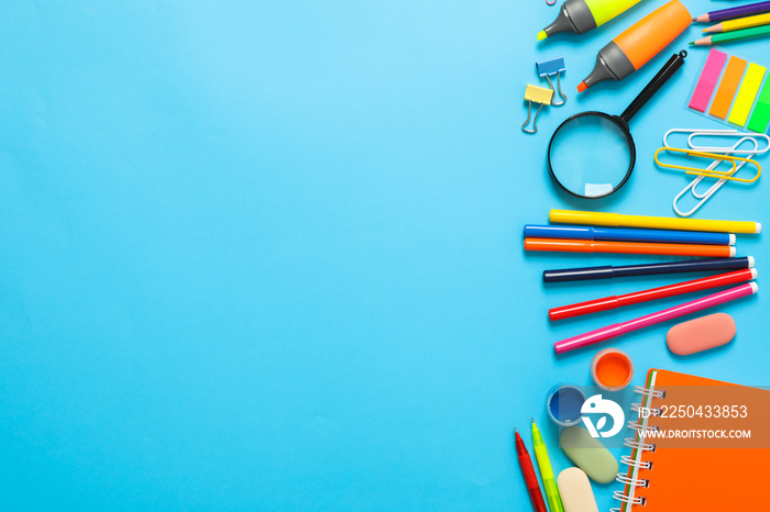 Flat lay composition with school supplies on color background, space for text