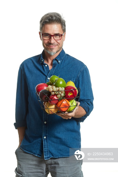 Casual older white man man holding basket of fruits - healthy eating.