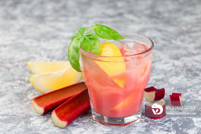 Refreshing lemonade with rhubarb, lemon, sparkling water and basil in a glass, horizontal