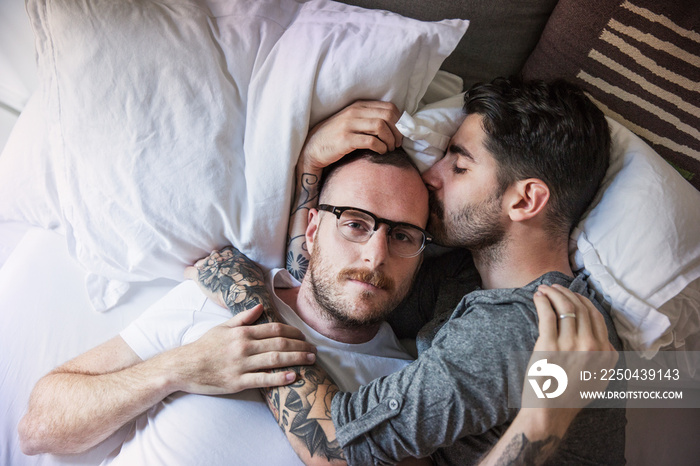 Couple relaxing on bed at home