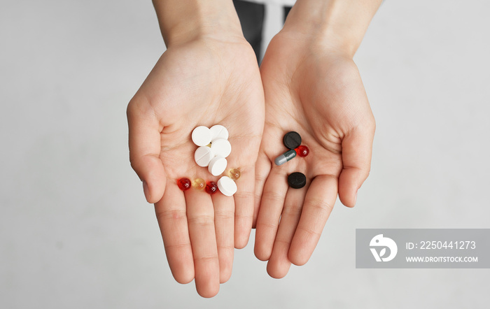 brunette in a white t-shirt with pills in her hands health problems