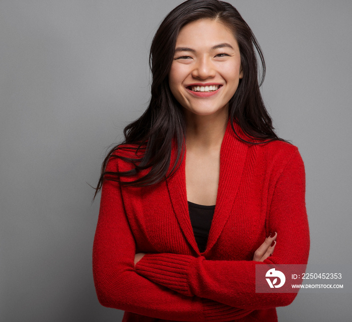 Portrait of young woman with arms crossed