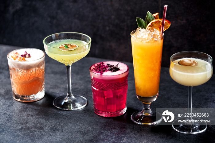 Five variously colored cocktails teasing the drinker