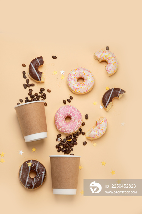 Donuts with coffee on yellow background.