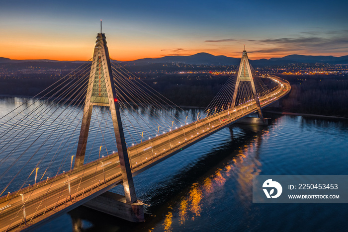 Budapest, Hungary - Aerial view of the beautiful illuminated cable-stayed Megyeri Bridge over River 