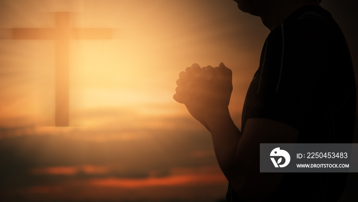 Christian man praying worship at sunset. Hands folded in prayer. worship god with christian concept 