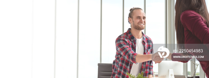 Confident young caucasian asian man shaking hands with partner woman in business agreement smiling t