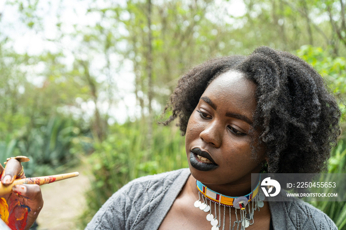 young female artist focused on her painting