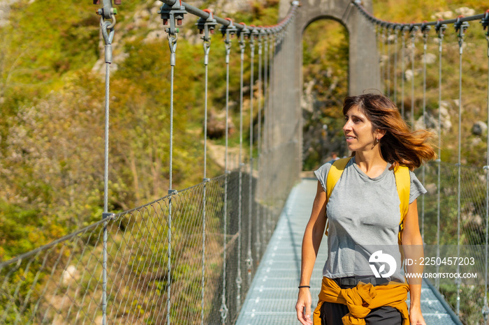 A hiker crossing the Holtzarte suspension bridge, Larrau. In the forest or jungle of Irati, north of