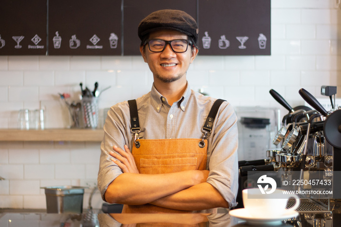 small business owner standing  crossed arm with coffee machine in his own coffee shop at counter