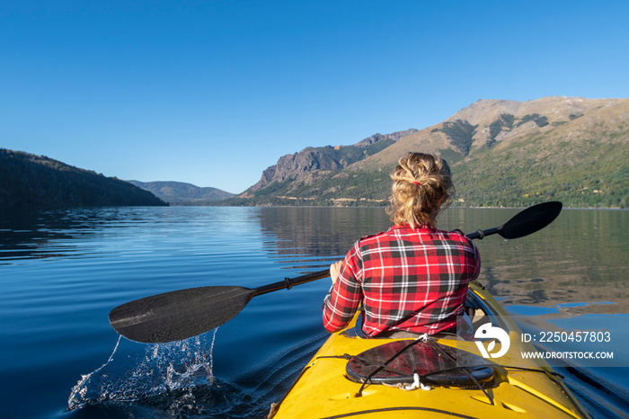 Woman paddling a kayak after being quarantined by covid-19