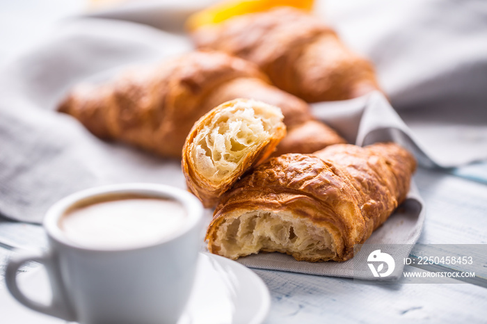 Fresh buttery croissants with coffee. Sweet morning breakfast concept.