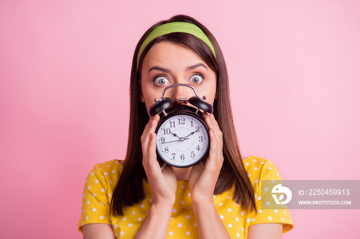 Portrait of young attractive shocked amazed surprised girl staring camera cover face hold clock isol