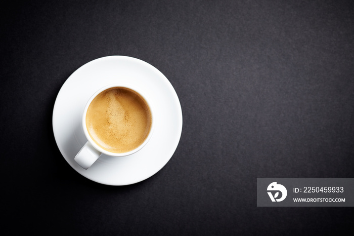 Cup of coffee on black background. Top view. Copy space.