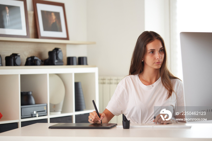 Portrait of beautiful caucasian graphic designer woman working home office with graphic board on des