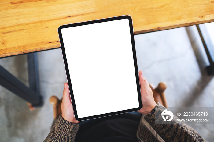 Top view mockup image of a woman holding black tablet pc with blank white desktop screen