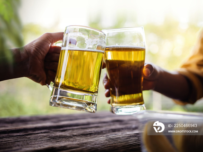 Two Friends making Cheers with Glasses and Drinking Beer at the Balcony in Summer