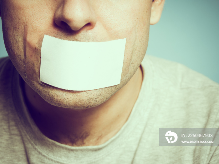 Caucasian man with duct tape on mouth, white .