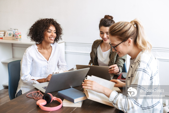 Group of cheerful young women studying together