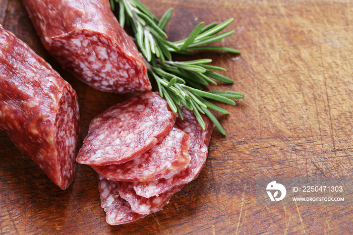 salami sausage with rosemary on a wooden board