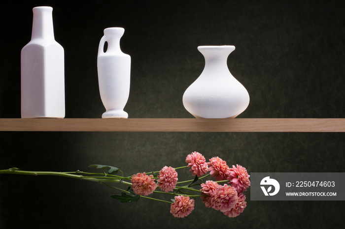 Still life with white vases and a flower branch