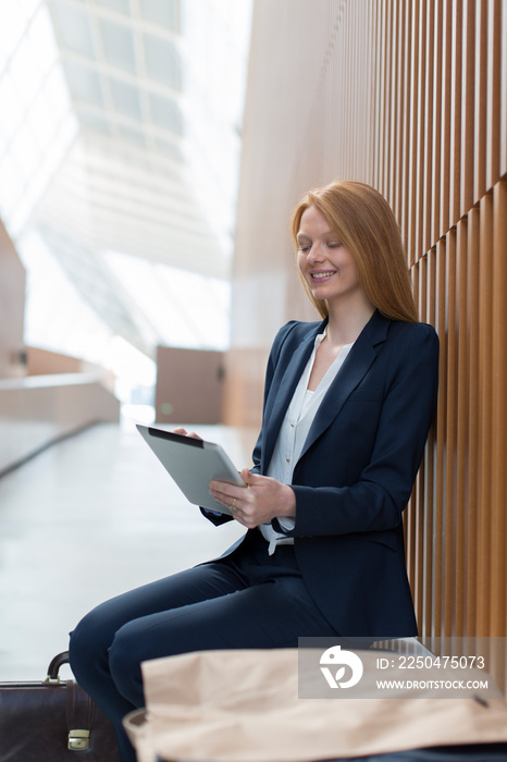 Businesswoman with digital tablet in modern office