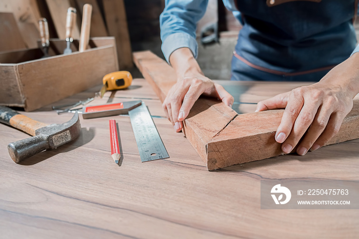 Carpenter working with equipment on wooden table in carpentry shop. woman works in a carpentry shop.