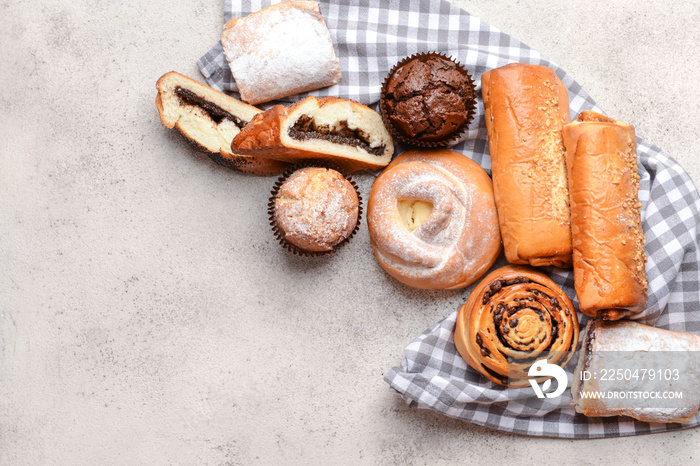 Heap of tasty pastries on grey background