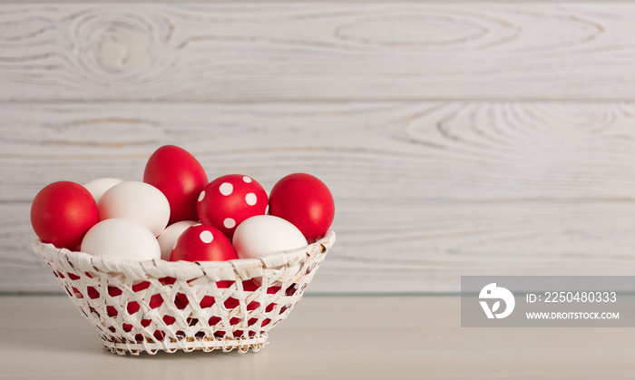 Happy Easter! Painted Easter eggs - red, white and red with white polka dots on a gray wooden backgr