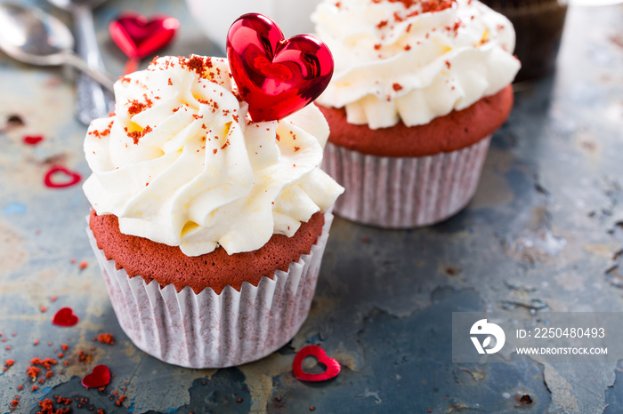 Delicious red velvet cupcakes decorated with hearts on rusty old metal background. Holiday food conc