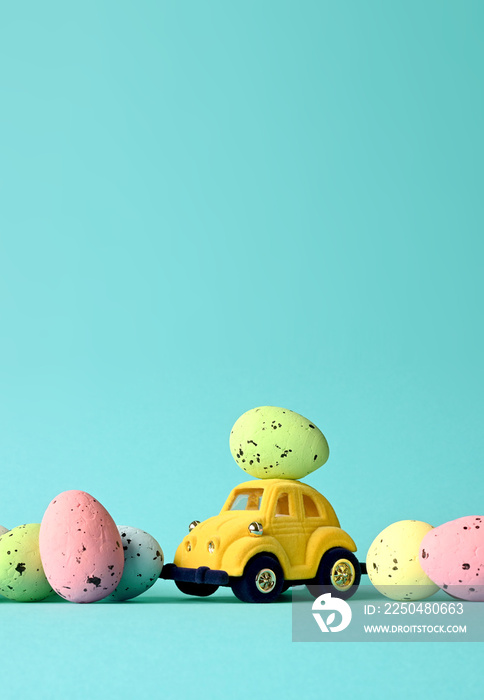 One Easter egg on a small car on a blue background. Copy space.