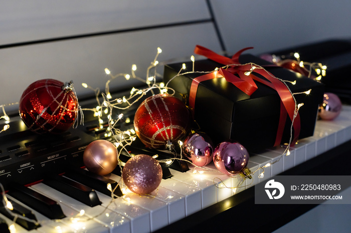 Piano keys with Christmas decorations, closeup