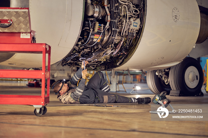 Ground crew working below a passenger airplane