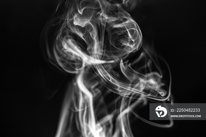 Smoke/fire/incense rising against black background