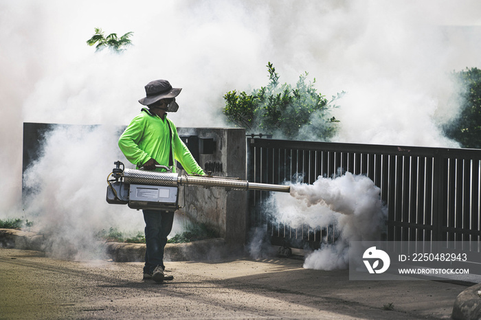 Man using fogger machine to control dangerous from mosquitoes