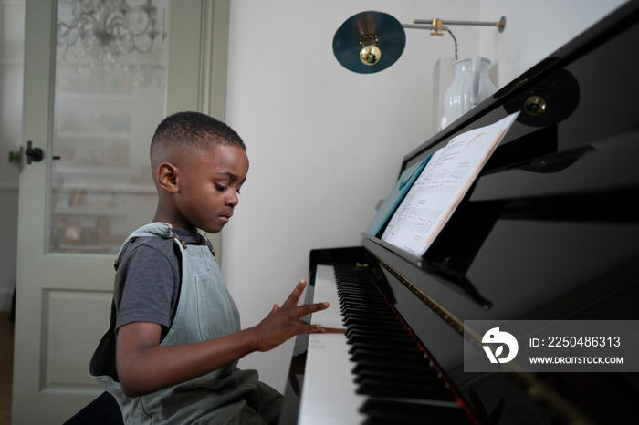 Boy (4-5) playing piano