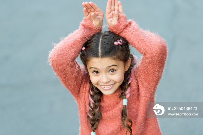 Cute bunny. Happy easter. Holiday bunny girl posing like rabbit grey background. Child smiling play 