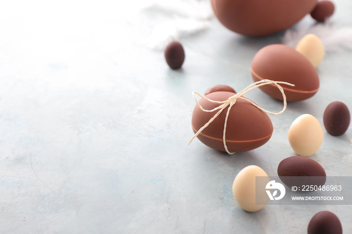 Tasty chocolate Easter eggs on light background