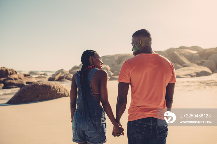 Man and woman in love strolling on the beach