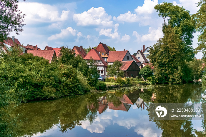 Grouping of beautiful traditional houses on the Wörnitz riverbank. Photography taken in Dinkelsbühl,